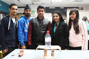 6th form students with paper bridge