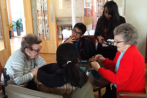  Students playing scrabble with residents