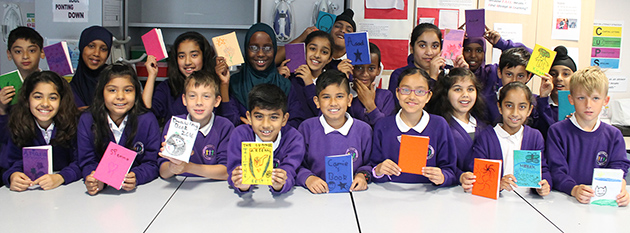  Students with the notebooks they made