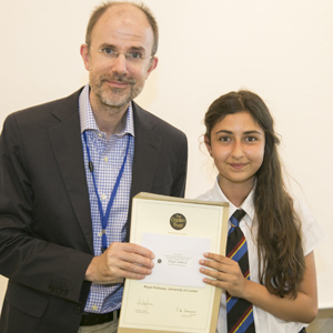  Riya receiving her award from Royal Holloway Physicist