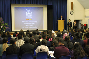  Headteacher talks to a packed Hall